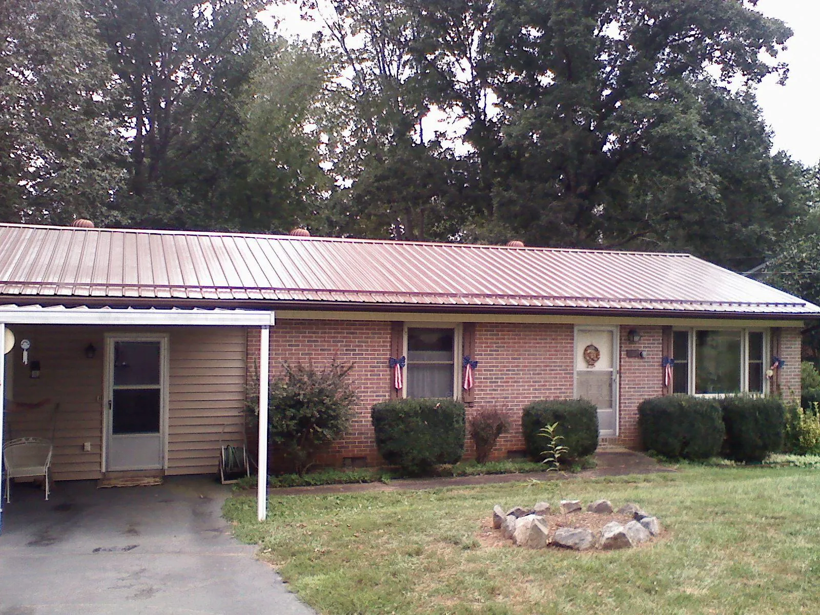 Bronze metal roof and carport on a brick ranch home — Roof Repair work by our crew in El Dorado Hills